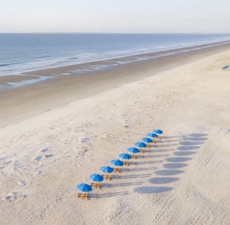 aerial shot of beach with umbrellas