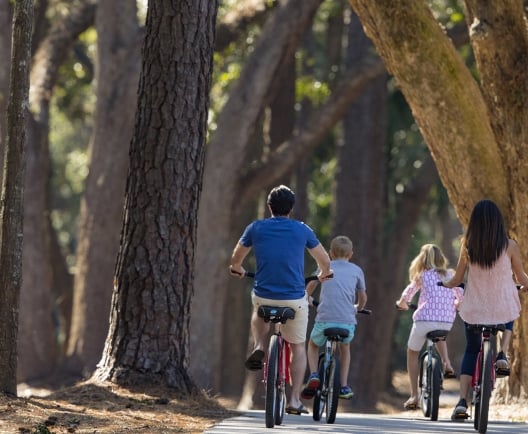 a family biking through trees