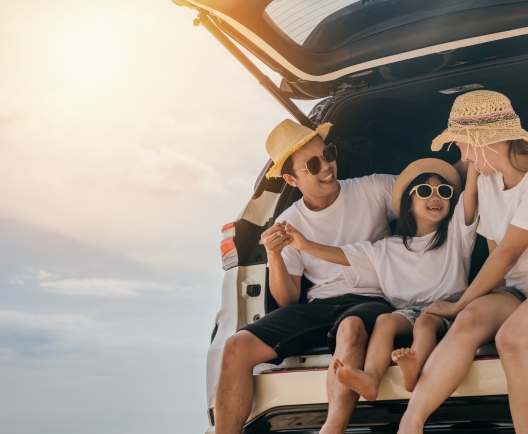 family sitting in the back of a car