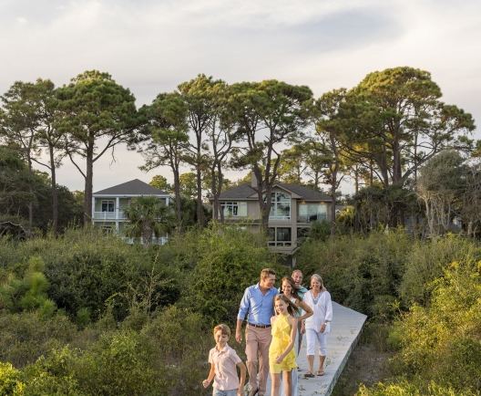 family walking on a boardwalk